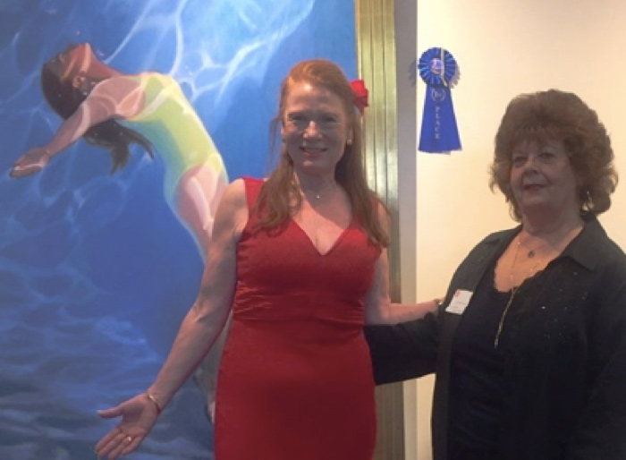 Candace Whitmore Lovely stands in front of her winning painting with Susan Hammond.