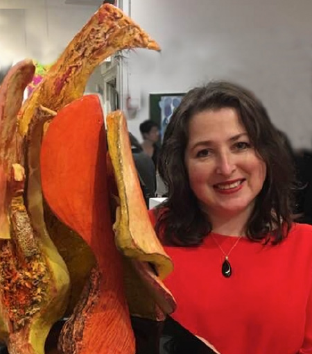 Natalia Koren Kropf with her sculpture titled FireBird.