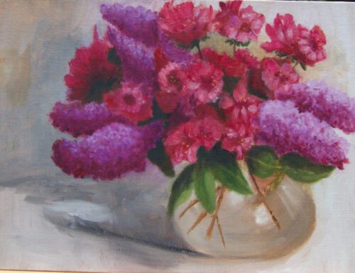 lilacs and azaleas in a clear vase