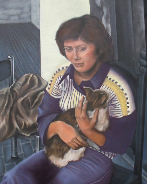 a woman in a purple sweater sits in a chair and holds a cat. she has a blank and zoned out expression