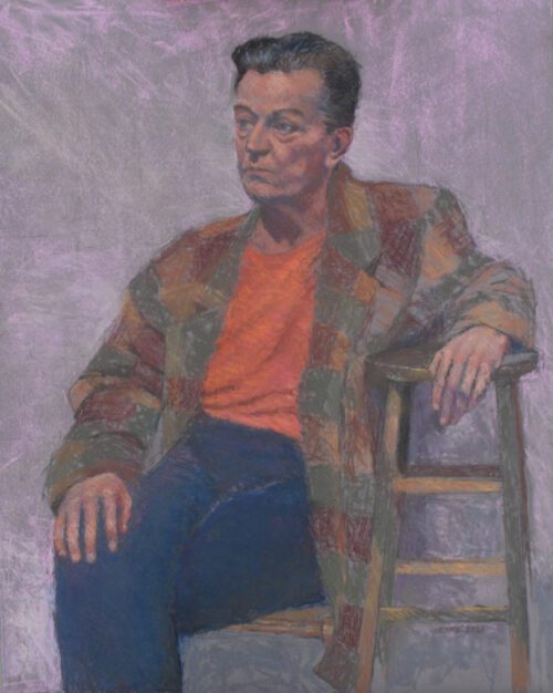 a man in jeans, an orange shirt and a striped sweater sits with one arm draped over a stool against a grainy purple background.
