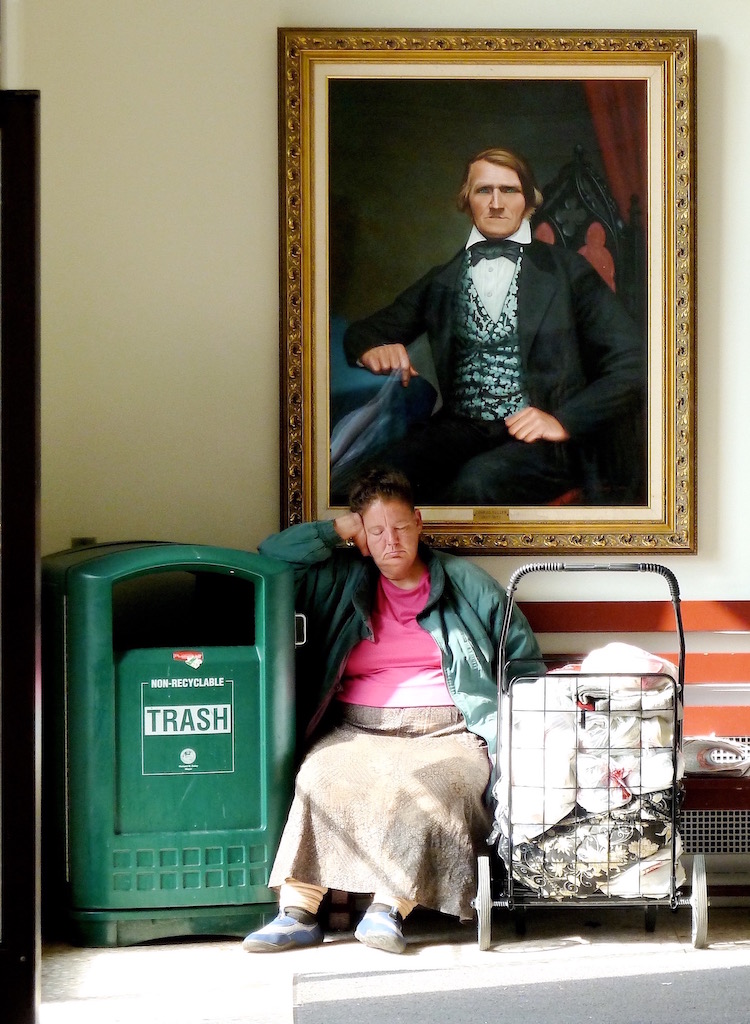 woman sitting under painting