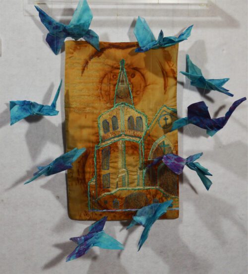 a church steeple surrounded by blue birds