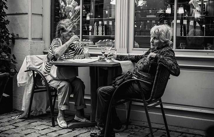 two women have a drink at sidewalk cafe